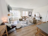 a living room with hardwood floors and a tv